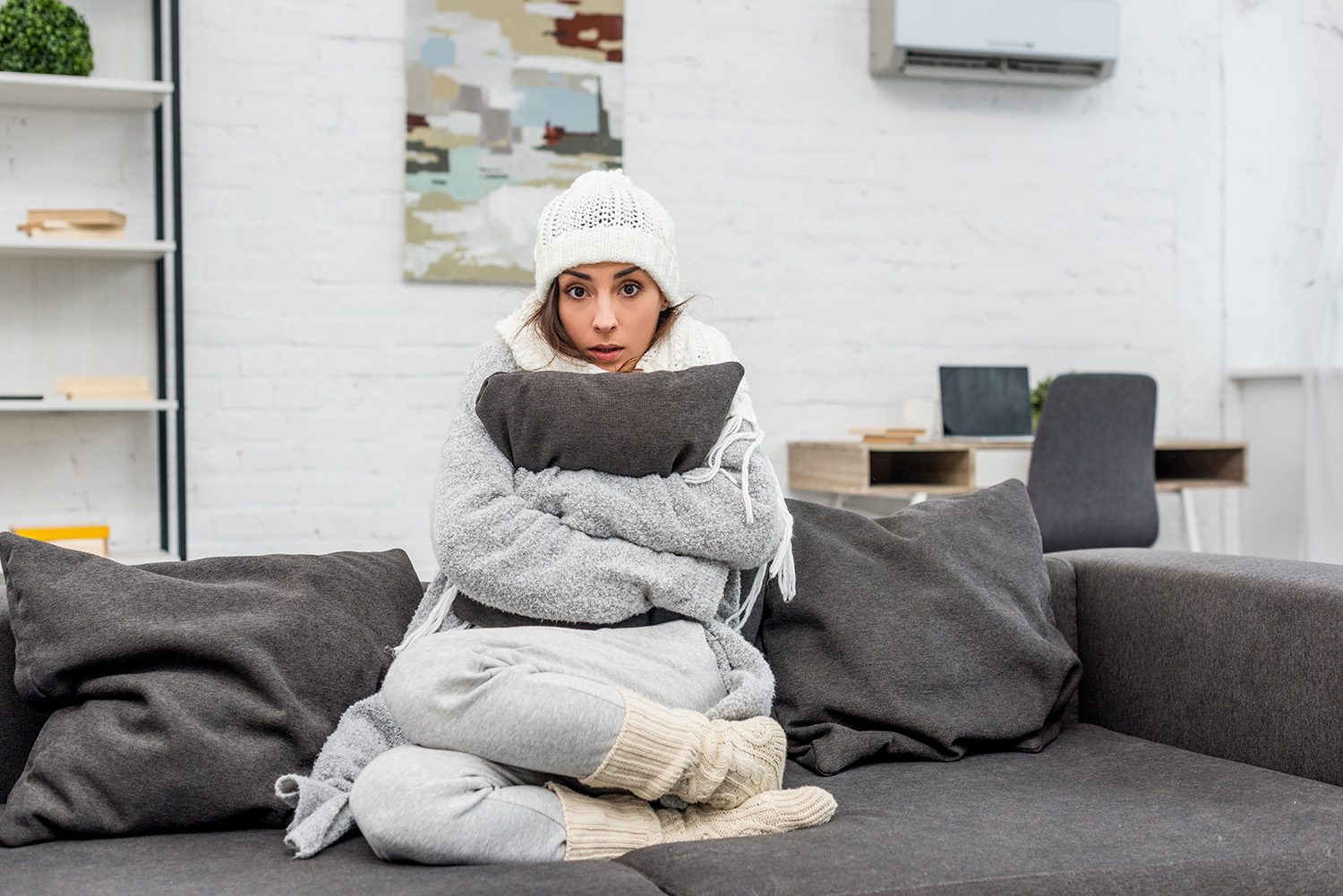 cold lady snuggled up on a couch